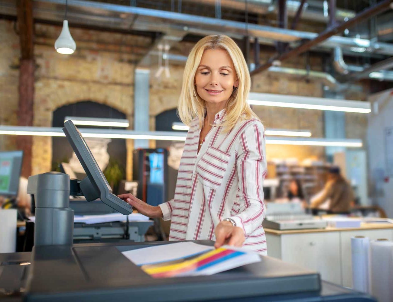 blonde woman choosing paper printing settings sel 2021 09 04 12 00 32 utc